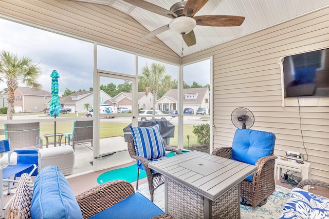 sunroom / solarium featuring ceiling fan and vaulted ceiling