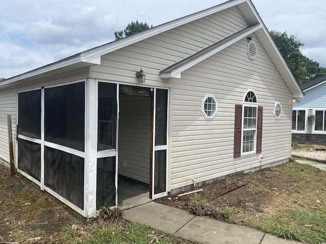 view of side of home featuring a sunroom