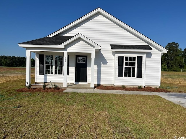 view of front of home with covered porch and a front lawn