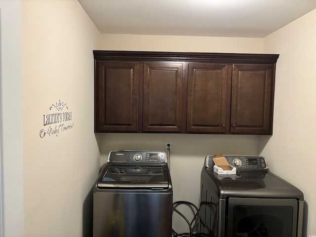 laundry room featuring cabinets and washing machine and clothes dryer