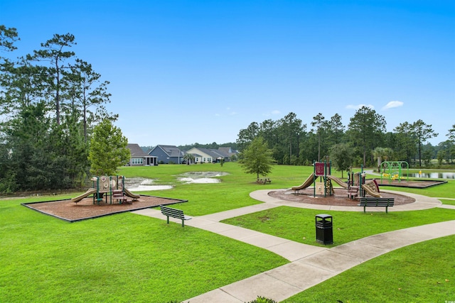 surrounding community featuring a yard, a water view, and a playground