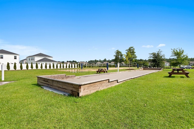 view of home's community with a yard and volleyball court