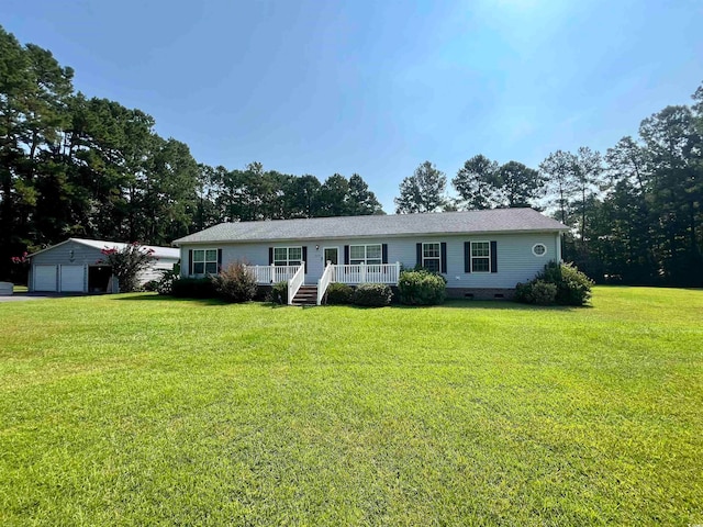 ranch-style house with an outbuilding, a garage, and a front lawn