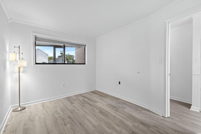 unfurnished room with light wood-type flooring and ornamental molding