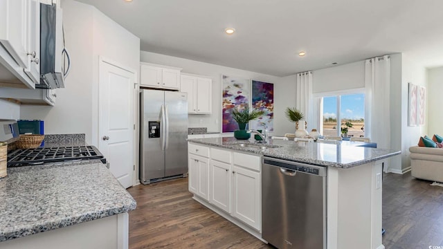 149 Pampa Dr, Loris, SC 29569 - kitchen featuring sink, white cabinetry, a center island with sink, stainless steel appliances, and light stone countertops