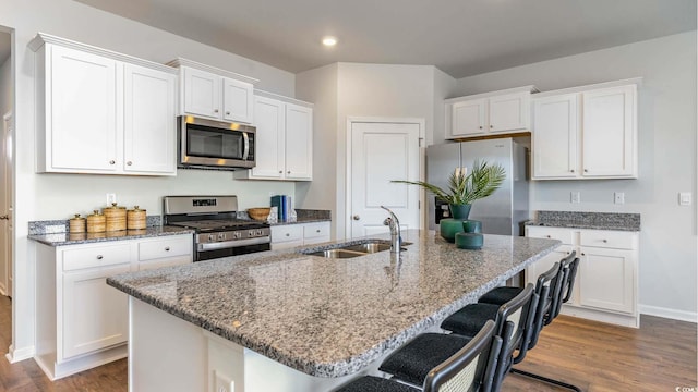 149 Pampa Dr, Loris, SC 29569 - kitchen featuring sink, white cabinetry, stainless steel appliances, an island with sink, and a kitchen bar