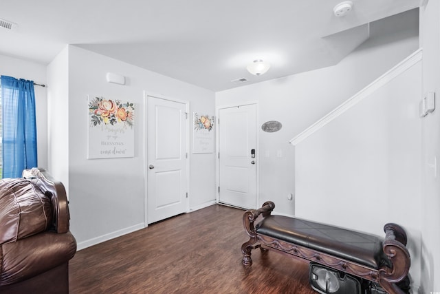 workout area featuring baseboards, dark wood-style flooring, and visible vents