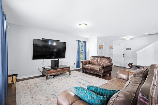 living room featuring baseboards and wood finished floors