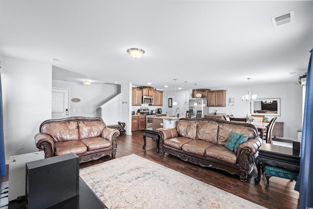 living room featuring dark wood-style floors, visible vents, an inviting chandelier, and recessed lighting