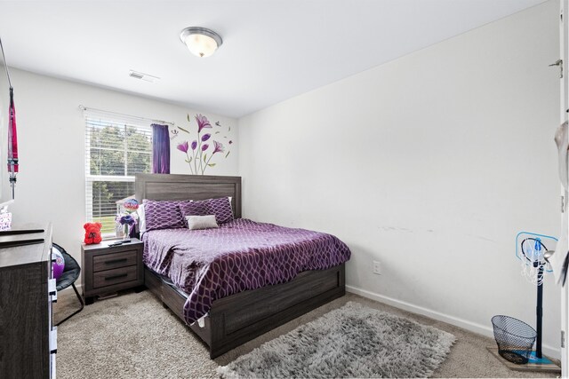 carpeted bedroom with baseboards and visible vents