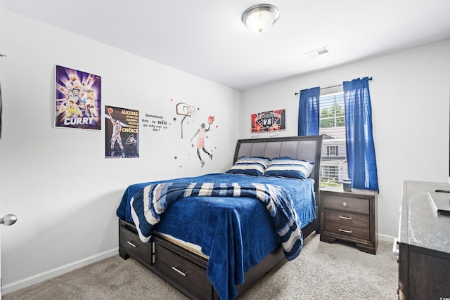 bedroom featuring light carpet, baseboards, and visible vents