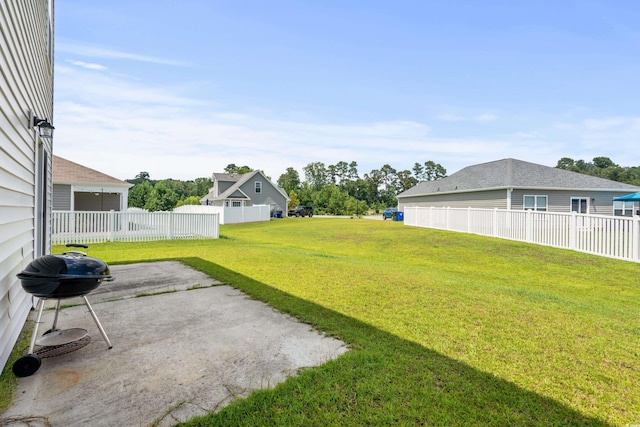 view of yard featuring fence and a patio