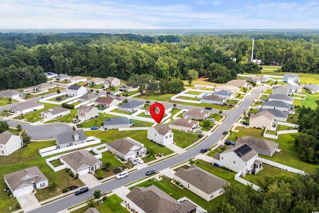 birds eye view of property with a residential view and a view of trees