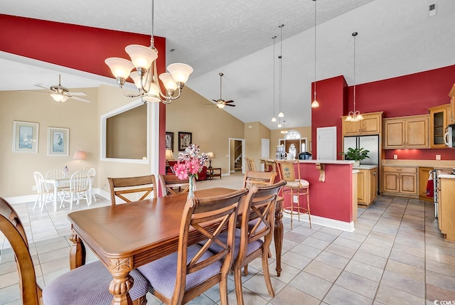 dining room featuring ceiling fan with notable chandelier, high vaulted ceiling, light tile patterned flooring, and a textured ceiling