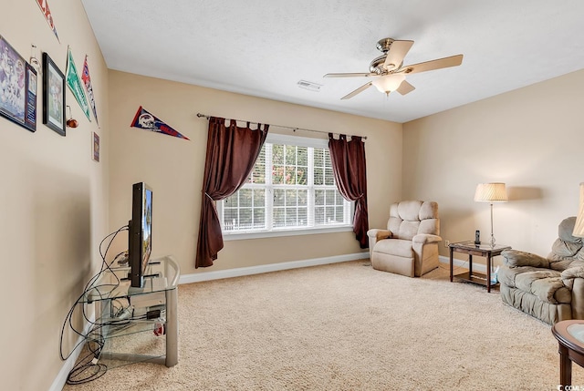 carpeted living room with ceiling fan