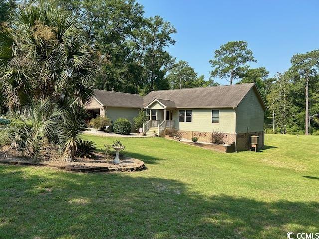 rear view of property with a yard