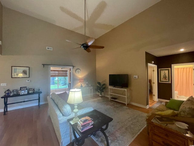 living room with hardwood / wood-style floors, high vaulted ceiling, and ceiling fan