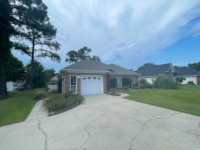 view of front of property featuring a garage and a front lawn