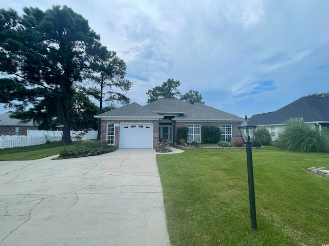 view of front of property with a garage and a front yard