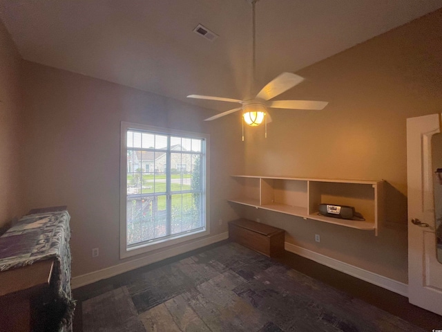 interior space featuring dark hardwood / wood-style floors, vaulted ceiling, and ceiling fan