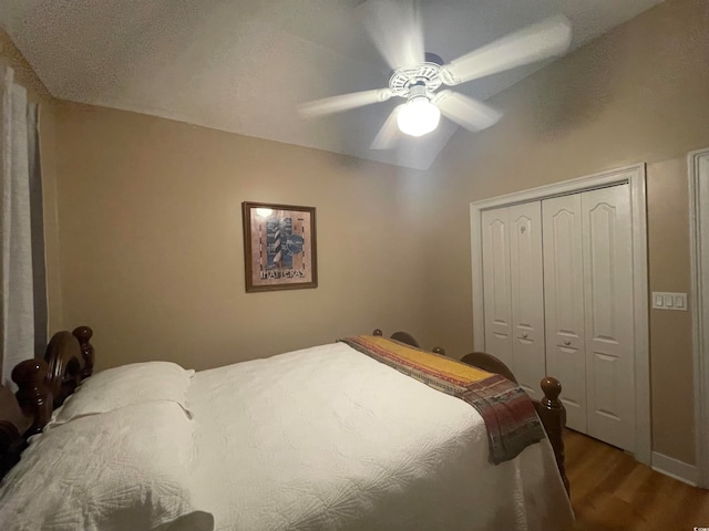 bedroom featuring ceiling fan, hardwood / wood-style flooring, and a closet