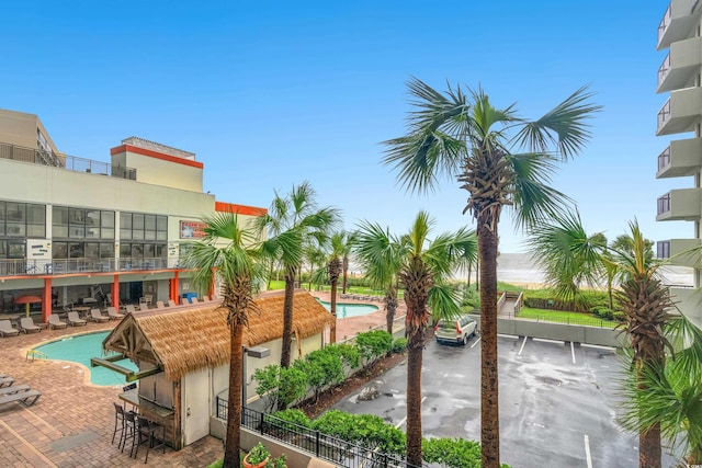 view of home's community featuring a patio area and a pool