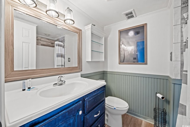 bathroom featuring hardwood / wood-style flooring, vanity, toilet, and ornamental molding