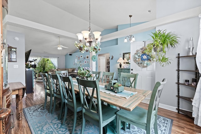 dining area featuring ceiling fan with notable chandelier, vaulted ceiling, and hardwood / wood-style flooring