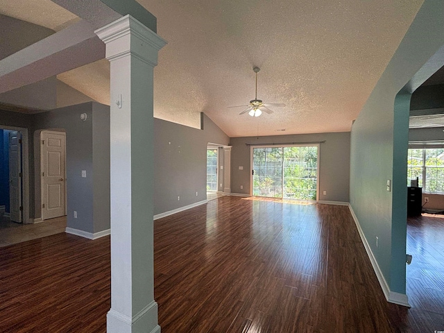 unfurnished room with ceiling fan, plenty of natural light, dark wood-type flooring, and a textured ceiling