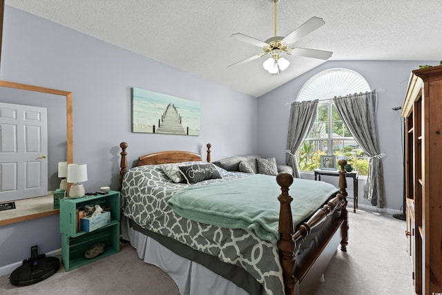 bedroom with a textured ceiling, vaulted ceiling, light carpet, and ceiling fan