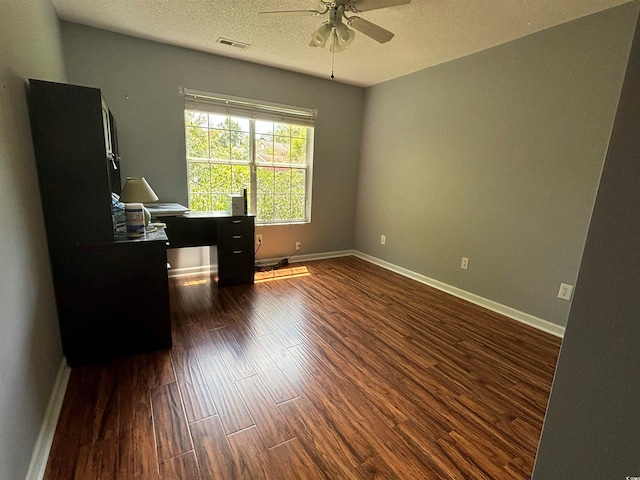 office space with ceiling fan, dark wood-type flooring, and a textured ceiling