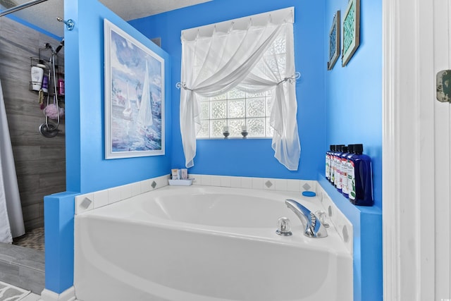 bathroom with a textured ceiling and plus walk in shower