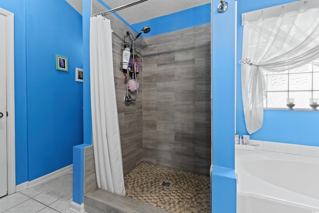 bathroom with a textured ceiling, shower with separate bathtub, and tile patterned floors