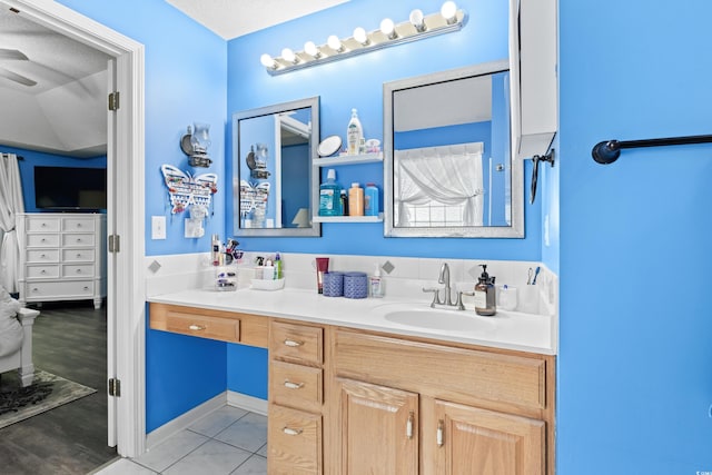 bathroom with vanity, tile patterned flooring, and a textured ceiling