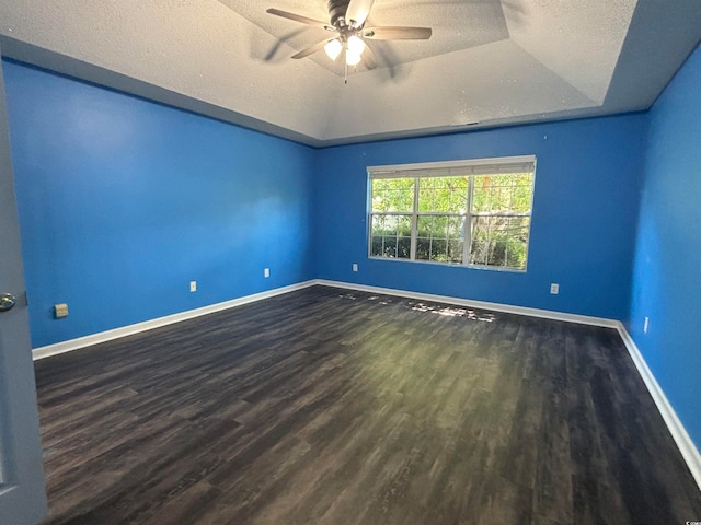 spare room featuring ceiling fan, a textured ceiling, a raised ceiling, and wood-type flooring