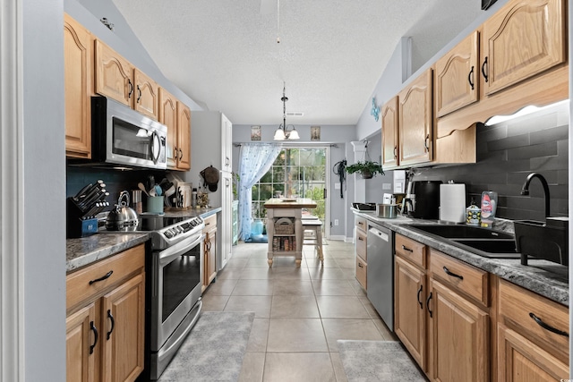 kitchen with a textured ceiling, tasteful backsplash, lofted ceiling, stainless steel appliances, and light tile patterned floors