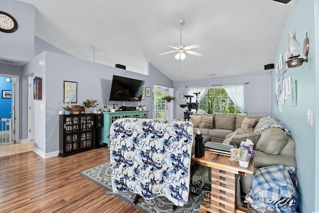 living room with wood-type flooring, vaulted ceiling, and ceiling fan