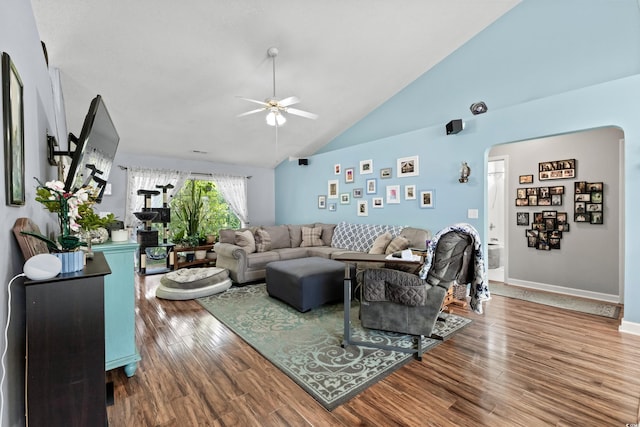 living room with ceiling fan, hardwood / wood-style floors, and high vaulted ceiling