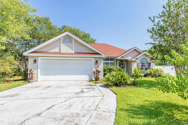 ranch-style home with a garage and a front lawn