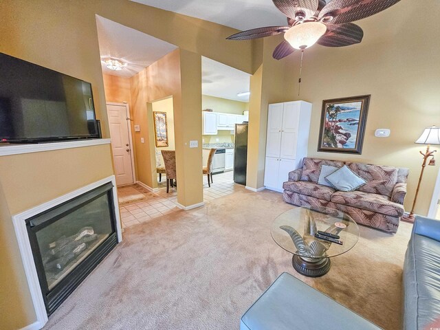 carpeted living room with ceiling fan