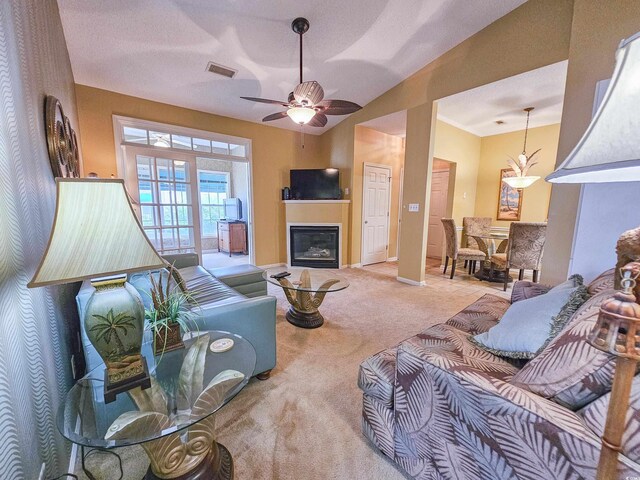 carpeted living room featuring ceiling fan