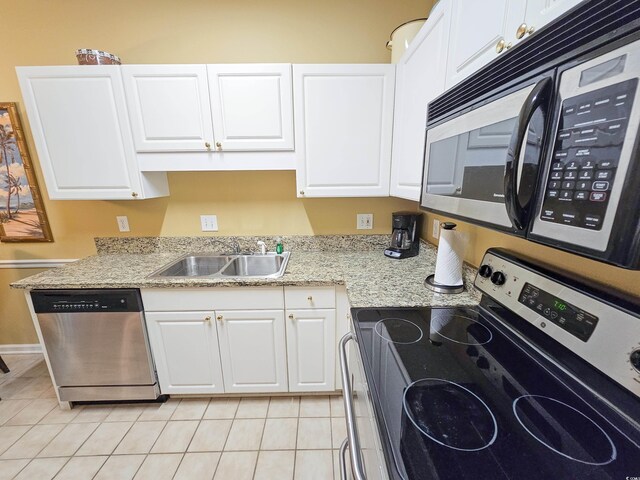 kitchen featuring separate washer and dryer, appliances with stainless steel finishes, white cabinetry, and light tile patterned flooring