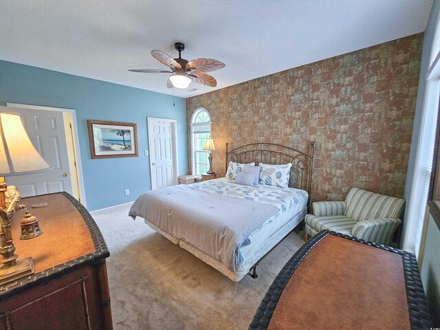 carpeted bedroom with a textured ceiling and ceiling fan