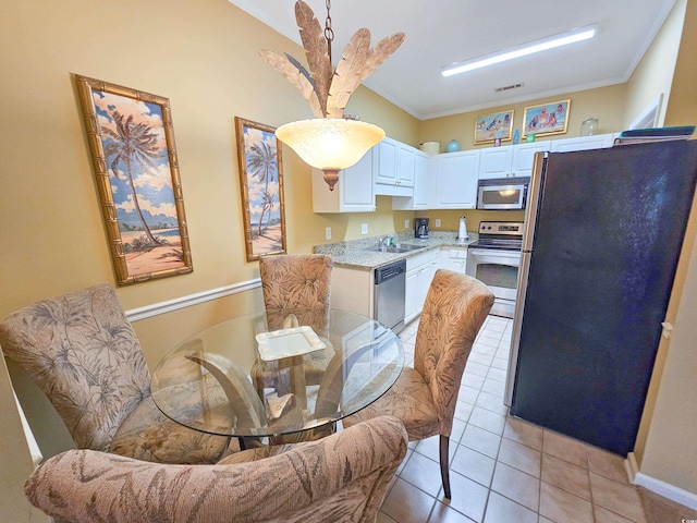 interior space featuring light tile patterned floors, ornamental molding, and sink