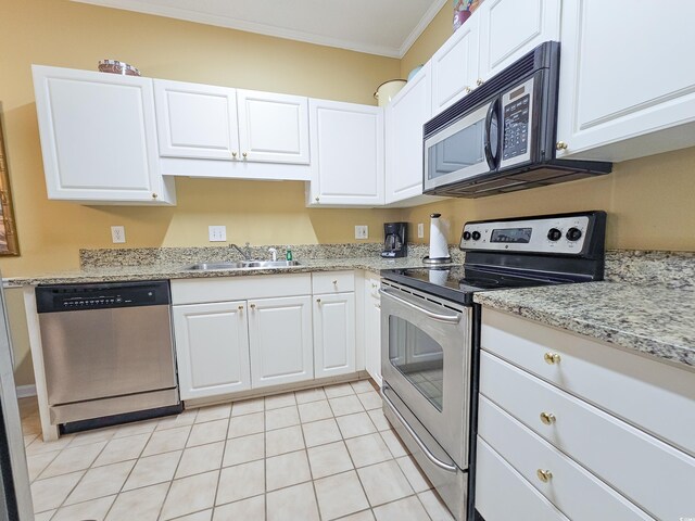 kitchen with sink, light tile patterned floors, appliances with stainless steel finishes, and white cabinets