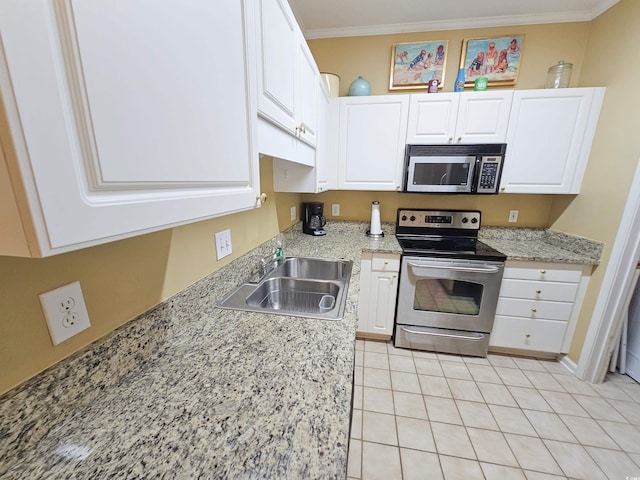 kitchen featuring white cabinets, light stone counters, sink, appliances with stainless steel finishes, and light tile patterned flooring