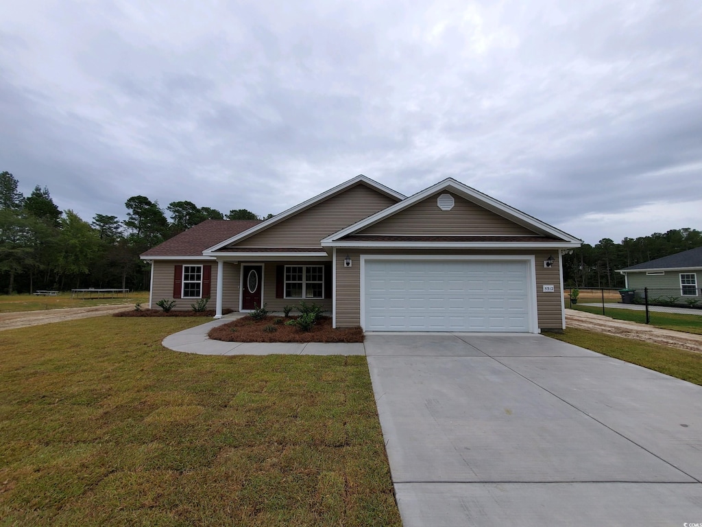 ranch-style house featuring a garage and a front yard