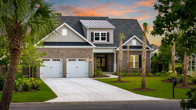 view of front of property featuring french doors, a yard, and a garage