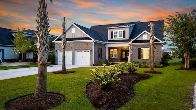 view of front facade featuring board and batten siding, concrete driveway, a yard, and brick siding