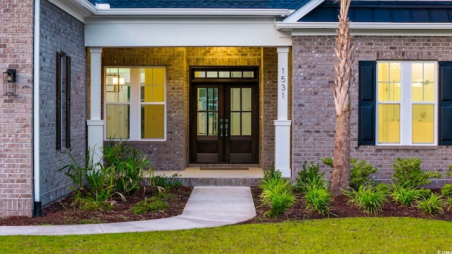entrance to property with brick siding and covered porch